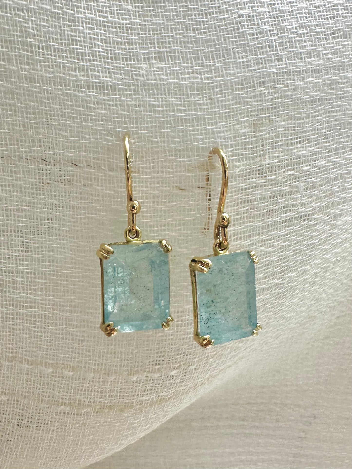 Elegant Drop Aquamarine Earrings handcrafted in 18 karat solid gold featuring emerald cut light green aquamarine stones in an open back prong setting and delicate french hooks. | Ella Creations Jewelry