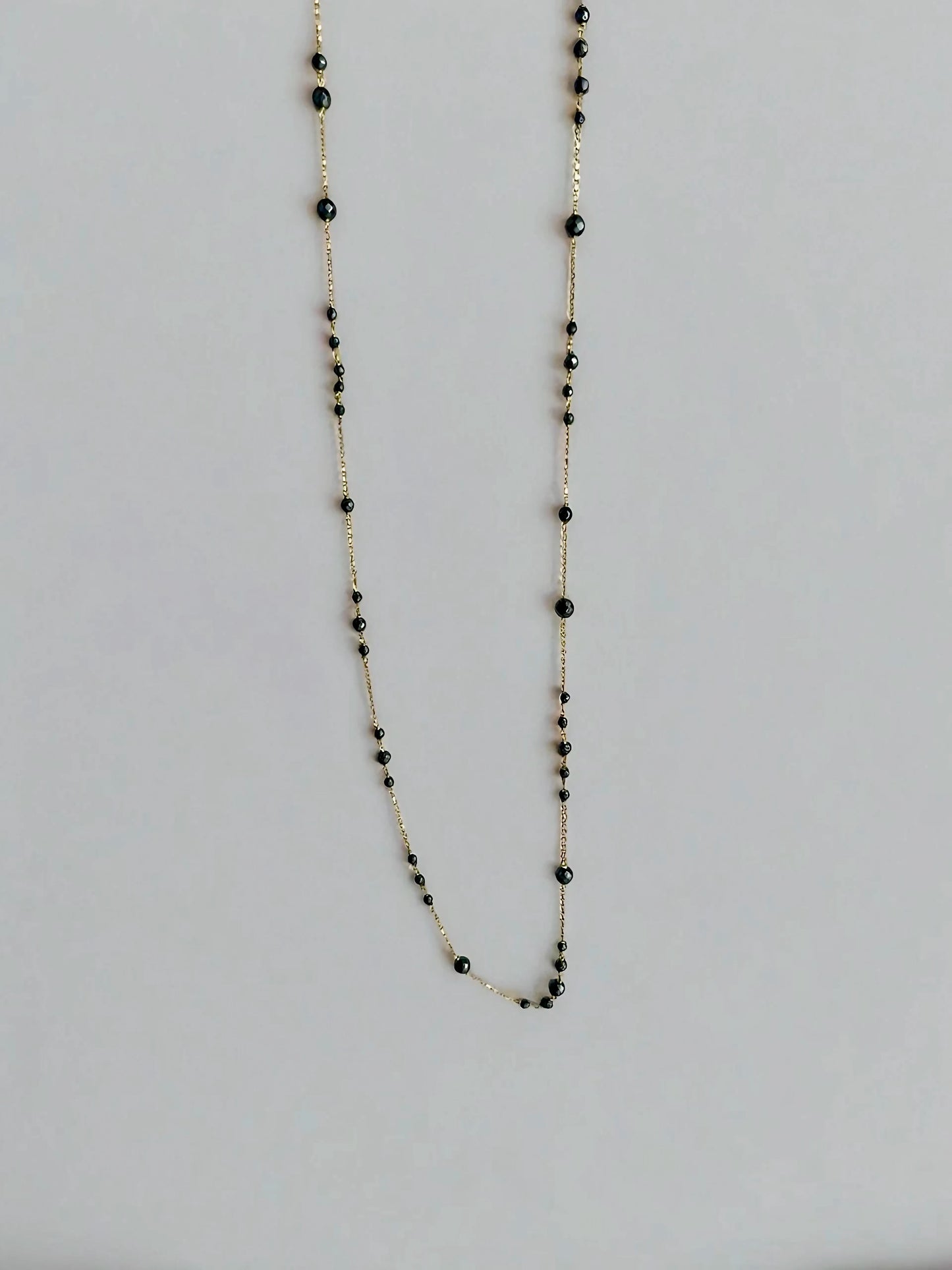 18k gold Hematite necklace, featuring a solid gold chain with hematite beads of different sizes spread through out the chain in different patterns. This necklace can be customized in different lengths from 23" to 16"
