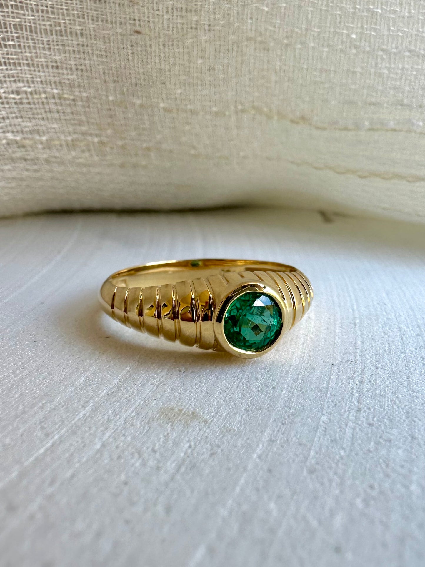 Natural Emerald Ring features a unique design that combines modern elements with a vintage-inspired aesthetic. It's a custom made ring showcasing a 5mm bezel set stone at its center which you can select among a Natural emerald, peridot or London Blue Topaz. The beautiful intricate ribbed pattern gives the ring a contemporary look and the central stone further enhances the elegance of this ring. | Ella Creations Jewelry