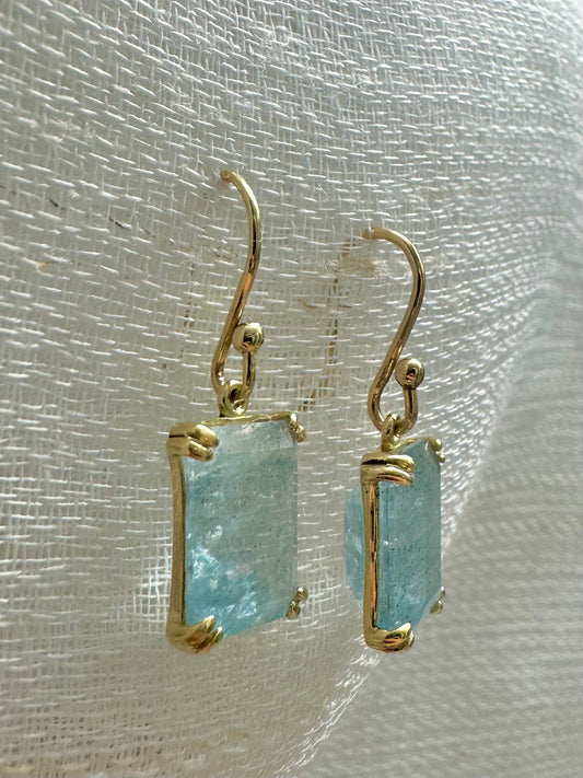 Elegant Drop Aquamarine Earrings handcrafted in 18 karat solid gold featuring emerald cut light green aquamarine stones in an open back prong setting and delicate french hooks. | Ella Creations Jewelry