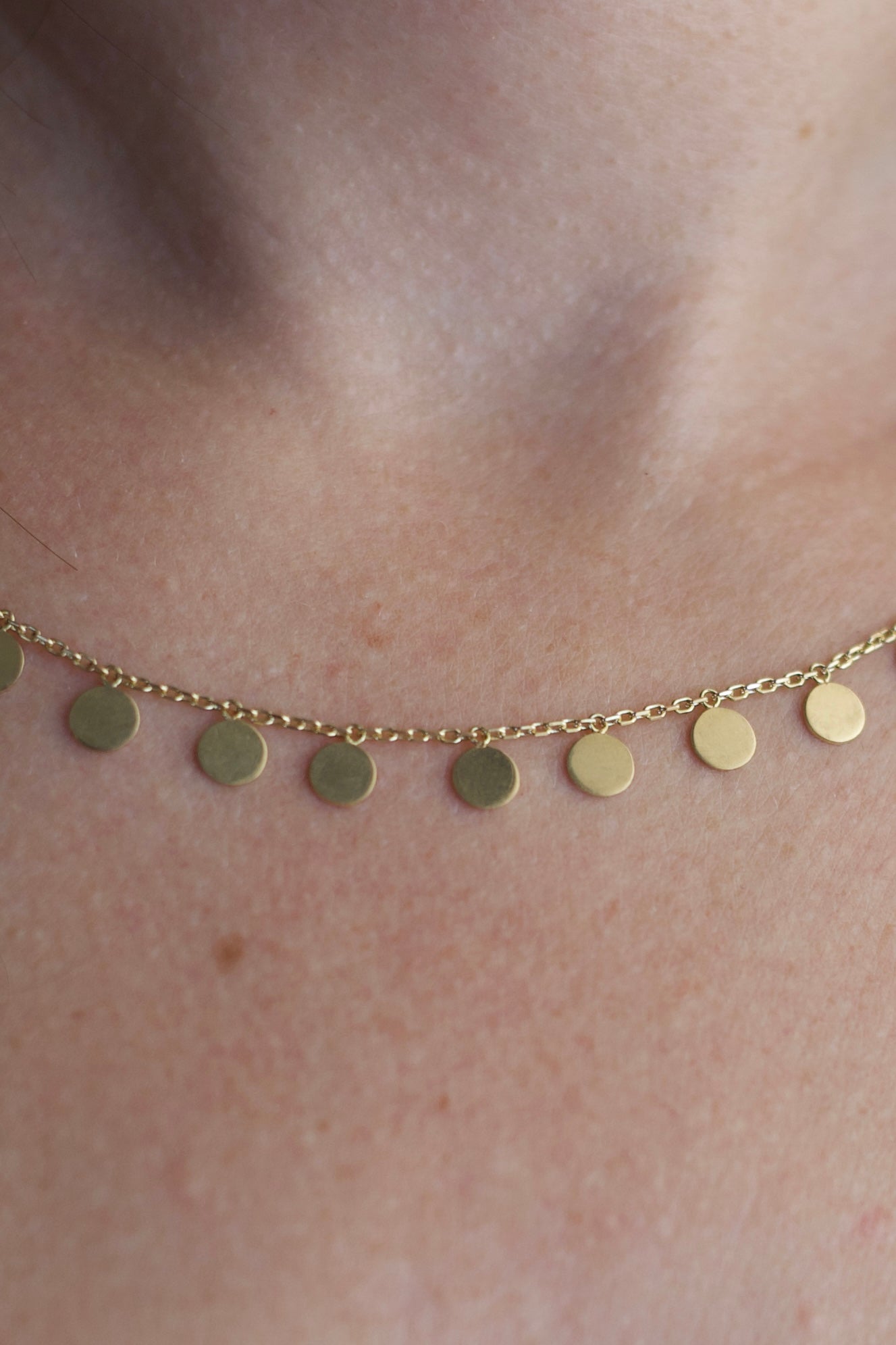 18K Gold Disc Necklace featuring 19 round discs measuring 5mm, available in 17" or 16"