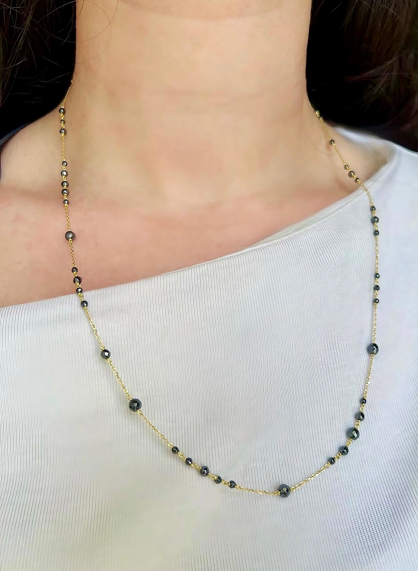 18k gold Hematite necklace, featuring a solid gold chain with hematite beads of different sizes spread through out the chain in different patterns. This necklace can be customized in different lengths from 23" to 16"