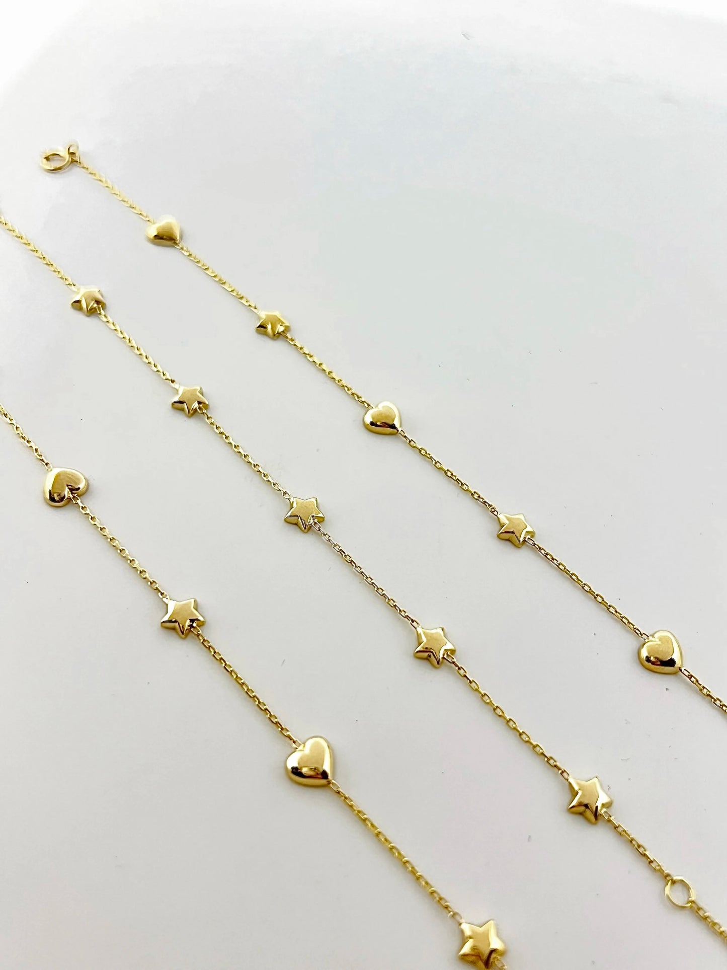 Chain Bracelet with Stars featuring five small puffy star charms or in alternative Stars and Hearts charms. This bracelet is perfect as everyday bracelet as it's handcrafted in 18 karat gold ensuring lifetime luster and resistance to tarnishing. 