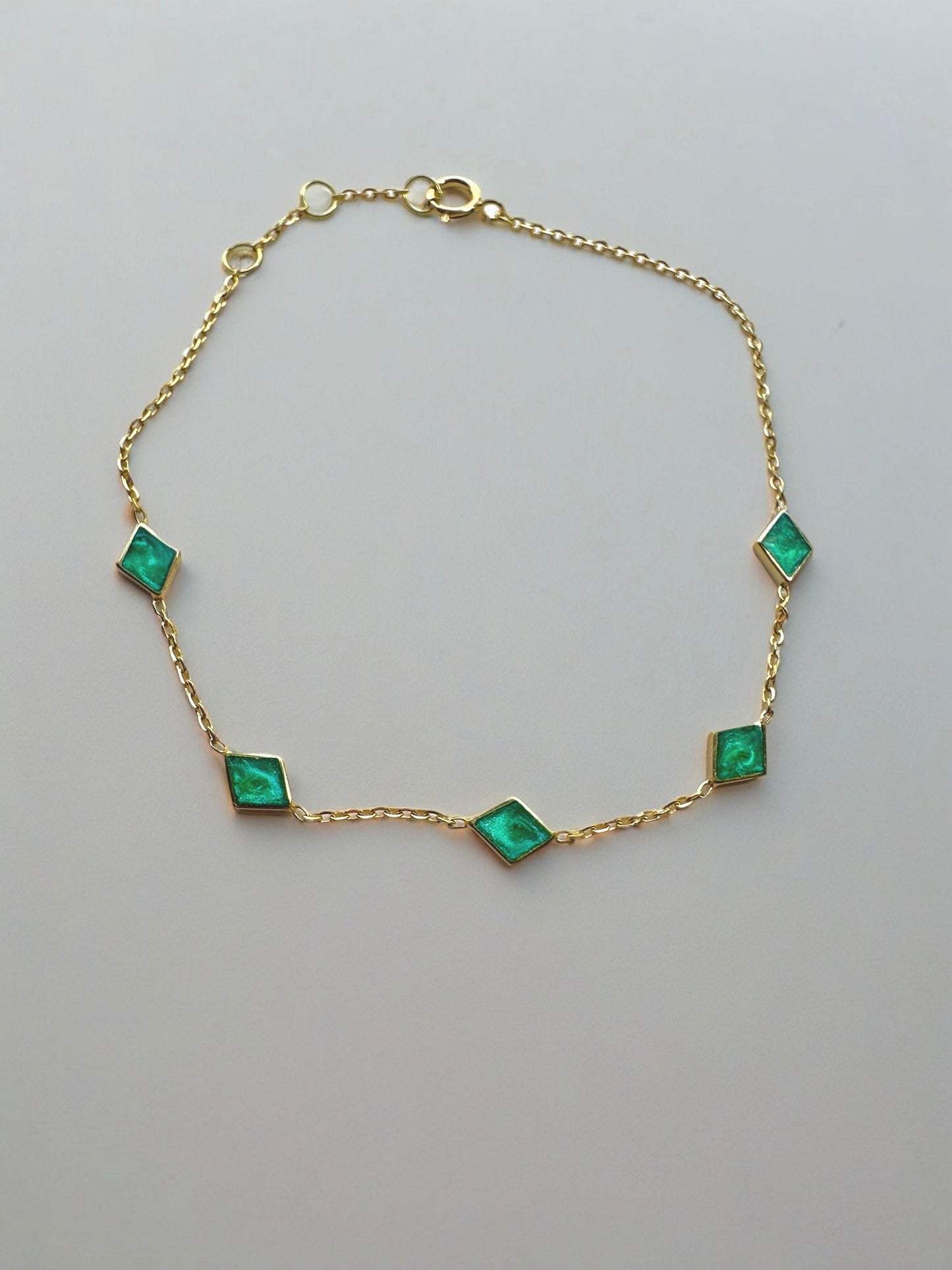 Handcrafted Rhombus Chain Bracelet, perfect for as an everyday bracelet and stacking. The dainty chain is adorned with 5 exquisite Rhombus charms, each featuring a hand-applied green malachite enamel finish. The bracelet is thoughtfully designed with an adjustable length, for a comfortable wear | Ella Creations Jewelry
