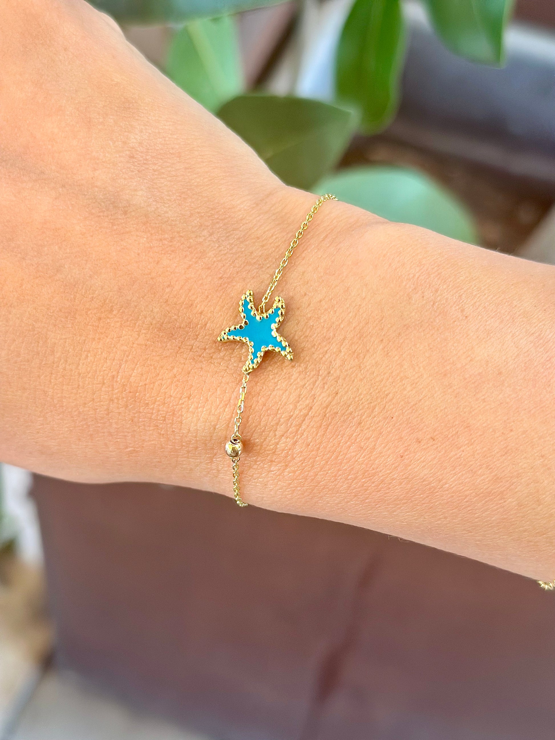 Exquisite Starfish Bracelet features a starfish charm at its center, available in Bright Turquoise and baby Pink finishes. Handcrafted in 18k gold and you can opt whether to have the charm only or an addition to a gold or enamel bead. | Ella Creations Jewelry