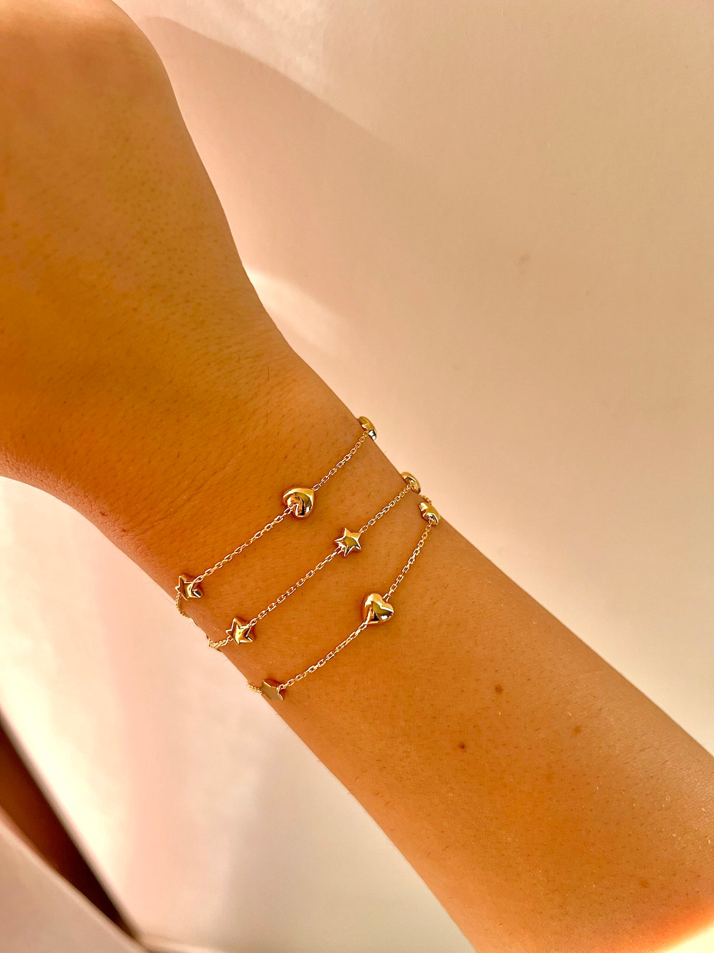 Chain Bracelet with Stars featuring five small puffy star charms or in alternative Stars and Hearts charms. This bracelet is perfect as everyday bracelet as it's handcrafted in 18 karat gold ensuring lifetime luster and resistance to tarnishing. 