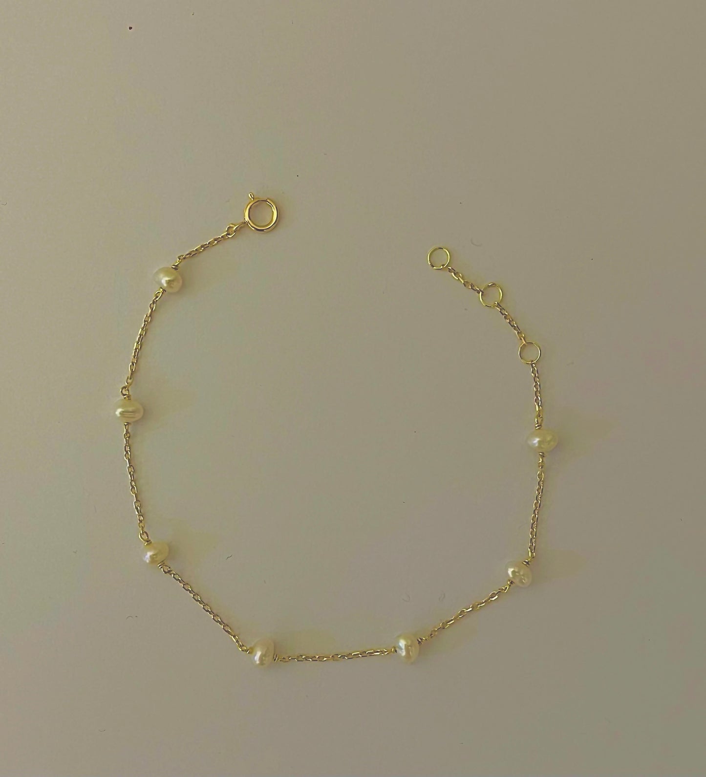 Exquisite Small gold bracelet handcrafted in 18 karat gold and adorned with 8 tiny freshwater pearls beads. Designed for versatility, this tiny beads bracelet is perfect for a minimalistic look or for stacking with other bracelets. | Ella Creations Jewelry