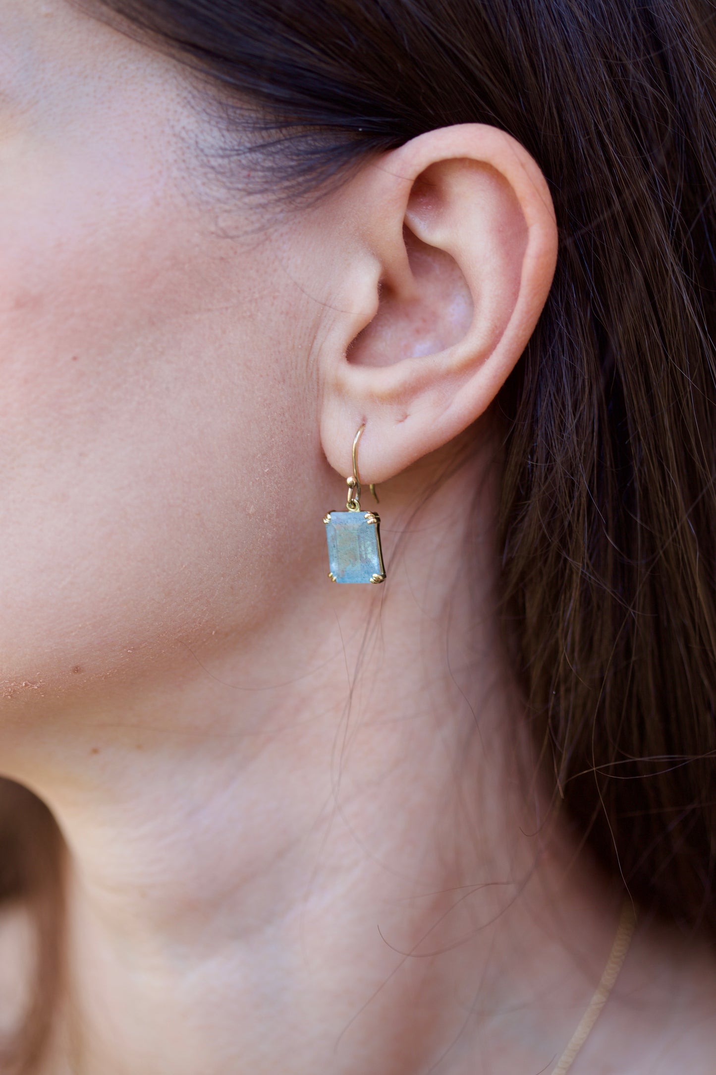 Elegant Drop Aquamarine Earrings handcrafted in 18 karat solid gold featuring emerald cut light green aquamarine stones in an open back prong setting and delicate french hooks. | Ella Creations Jewelry