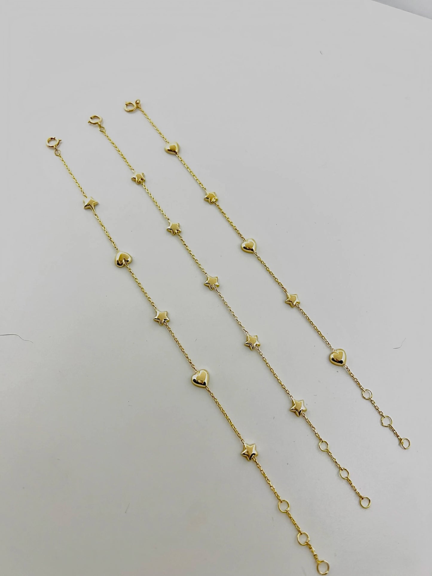 Bracelet with Stars featuring five small puffy star charms or in alternative Stars and Hearts charms. This bracelet is perfect as everyday bracelet as it's handcrafted in 18 karat gold ensuring lifetime luster and resistance to tarnishing. 