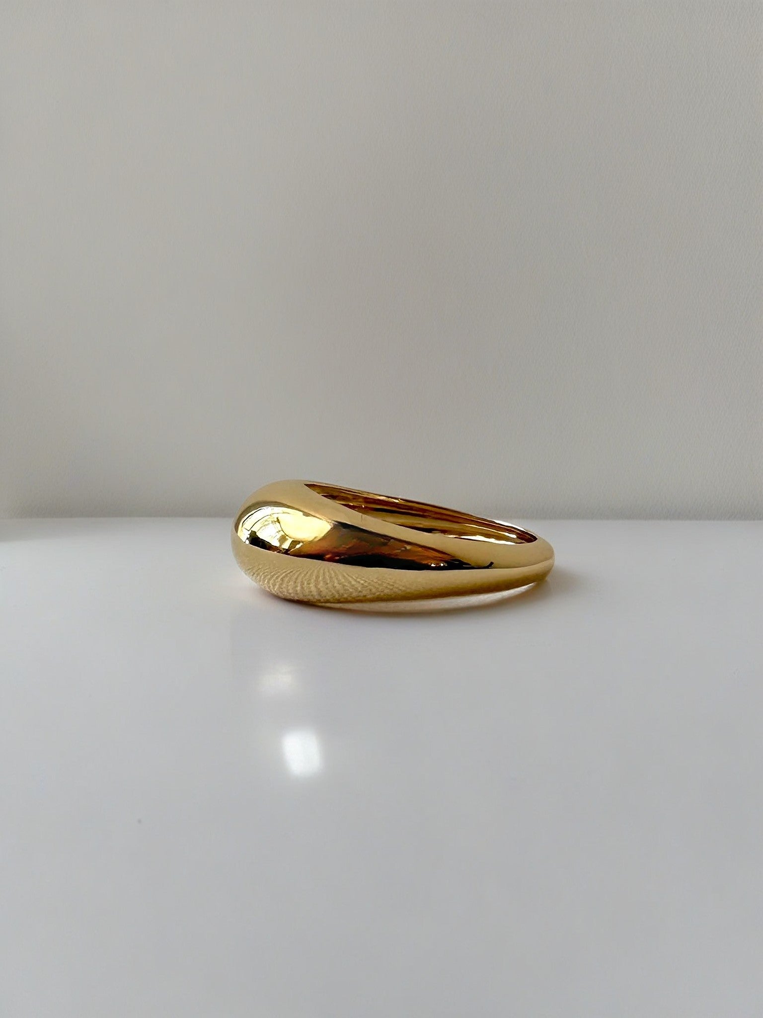 Gold Dome Ring handcrafted in 14k or 18k solid gold, the ring tampers from 7.5mm to 3mm | Ella Creations Jewelry