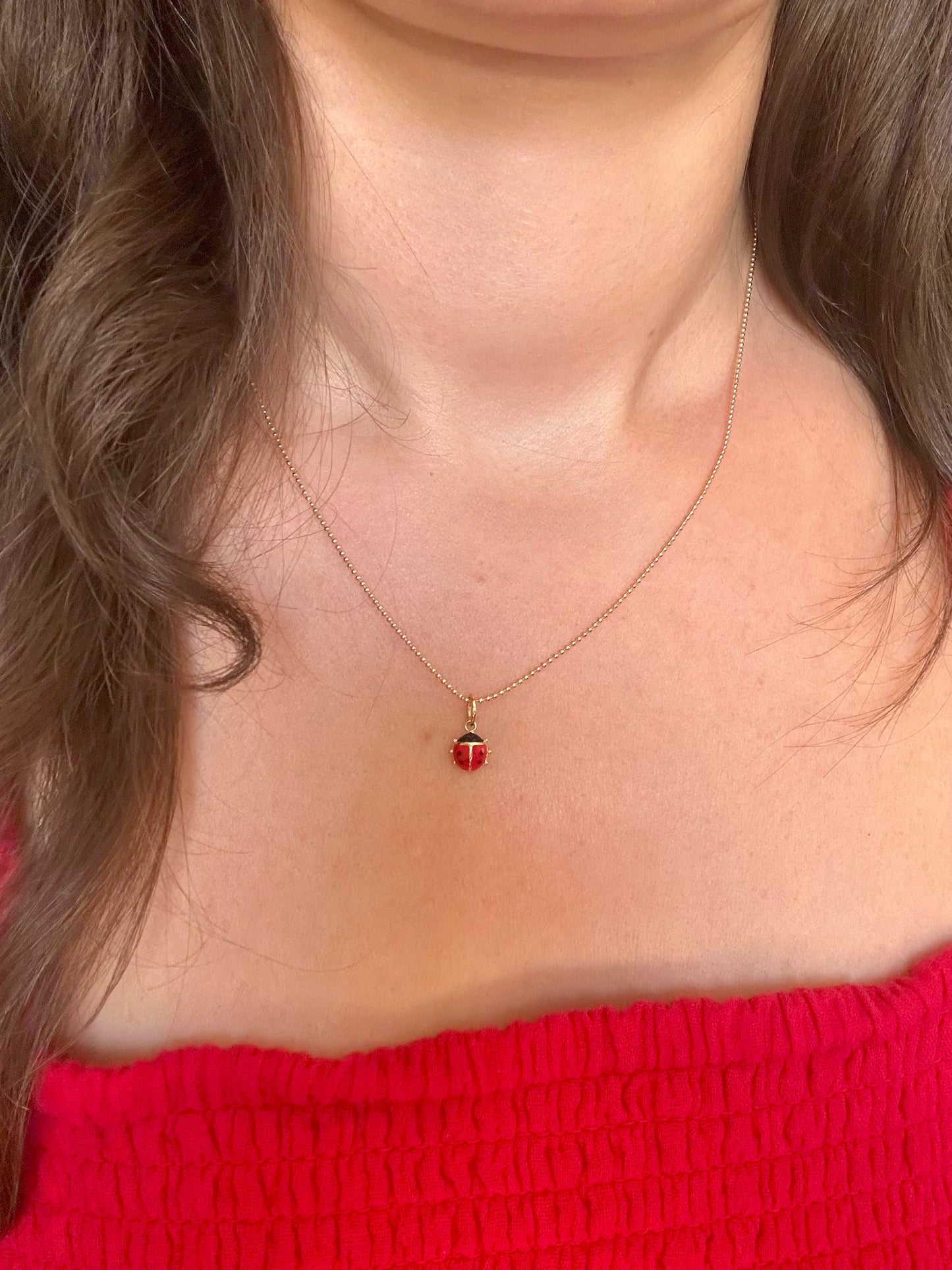 18k Gold ladybug Charm, crafted in 18k yellow gold and beautifully accented with vibrant red and black enamel. 