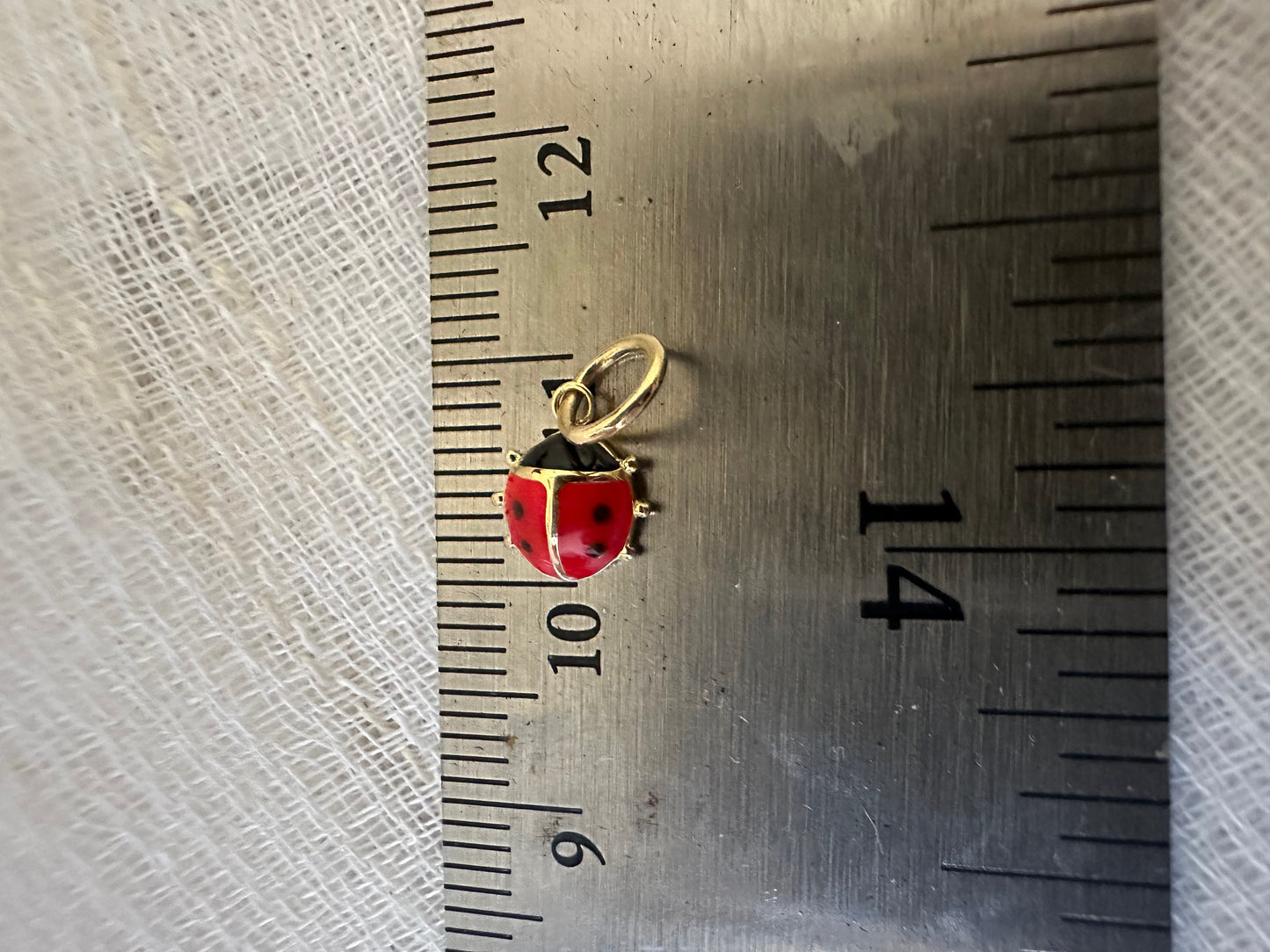 18k Gold ladybug Charm, crafted in 18k yellow gold and beautifully accented with vibrant red and black enamel. 
