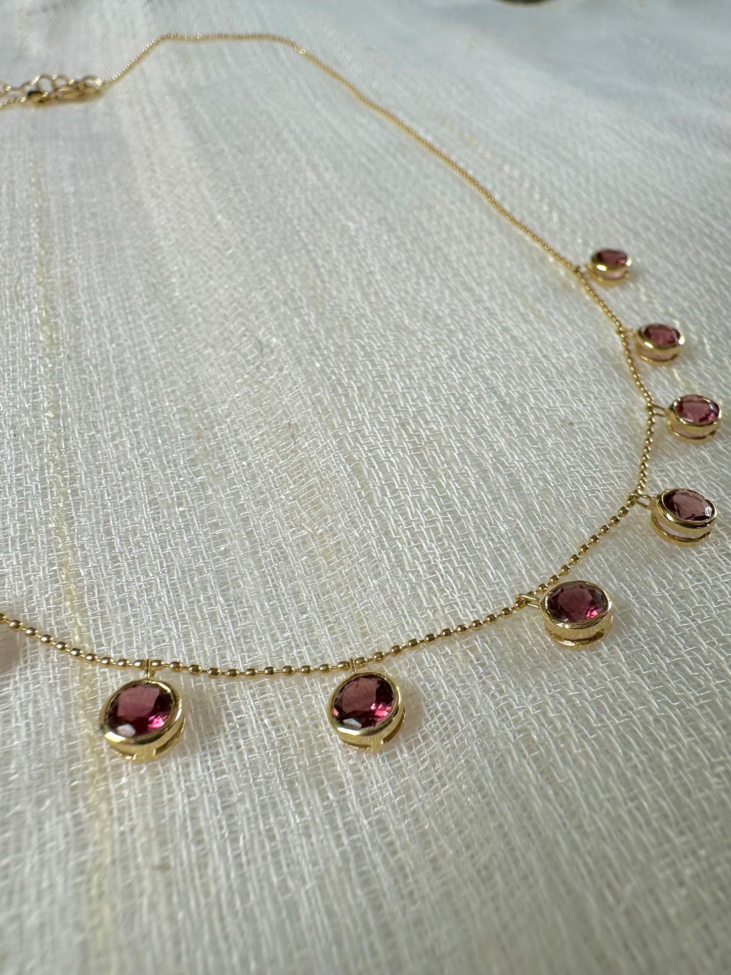 Handcrafted 18k Pink Tourmaline Station Necklace featuring nine pink tourmalines bezel set and dangling from a dainty ball chain necklace. Perfect as October Birthstone gift | Ella Creations Jewelry