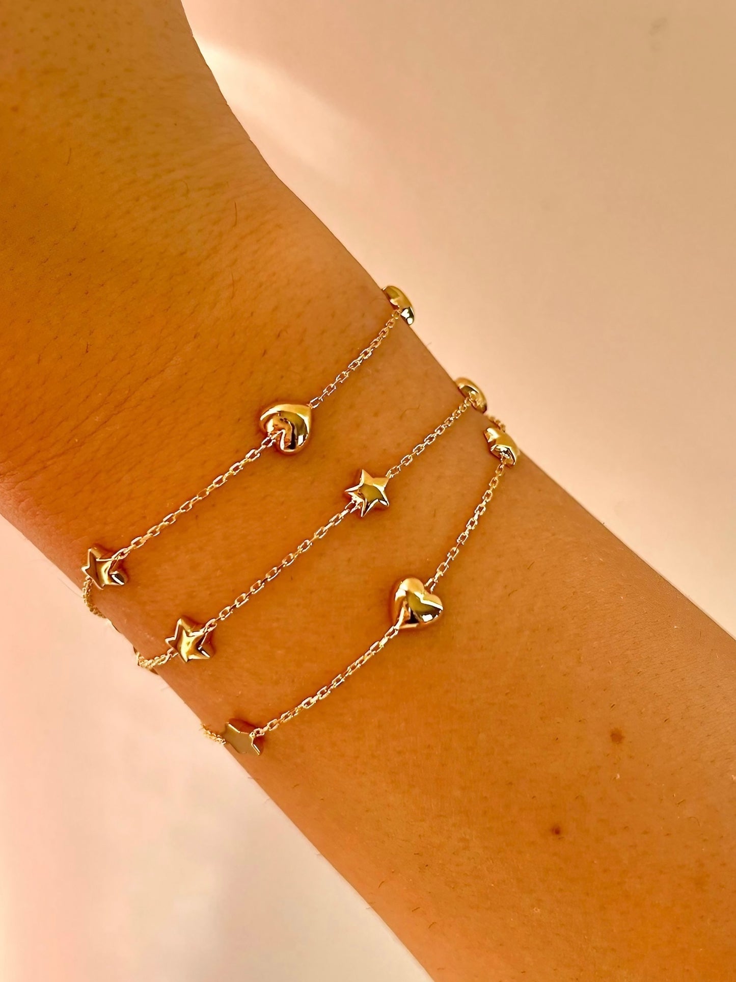 Chain Bracelet with Stars featuring five small puffy star charms or in alternative Stars and Hearts charms. This bracelet is perfect as everyday bracelet as it's handcrafted in 18 karat gold ensuring lifetime luster and resistance to tarnishing. 