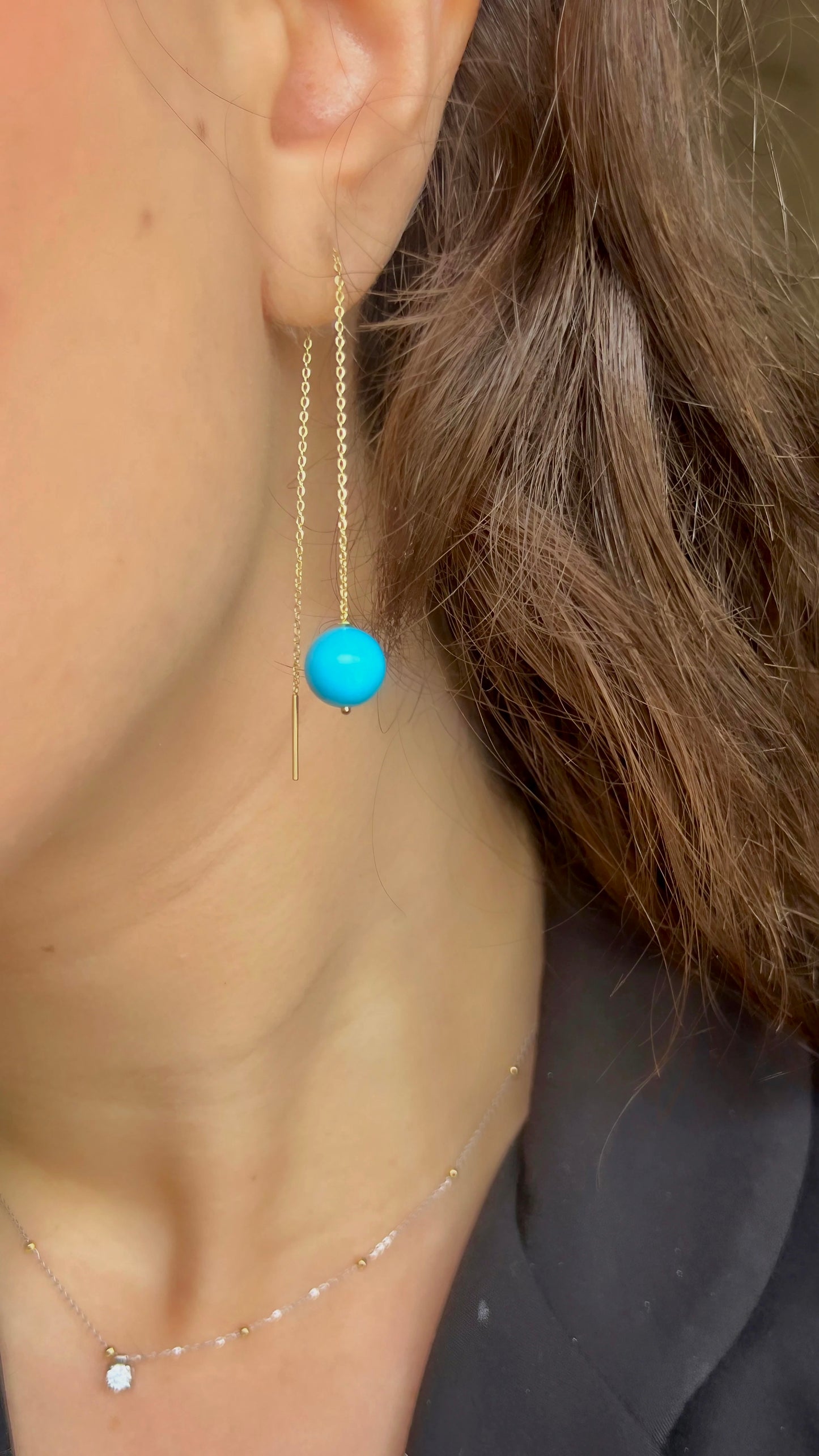 Delicate Gold Threader Earrings featuring a minimalist design that effortlessly blends modern chic with timeless charm. Adorned with a round turquoise bead at its end.