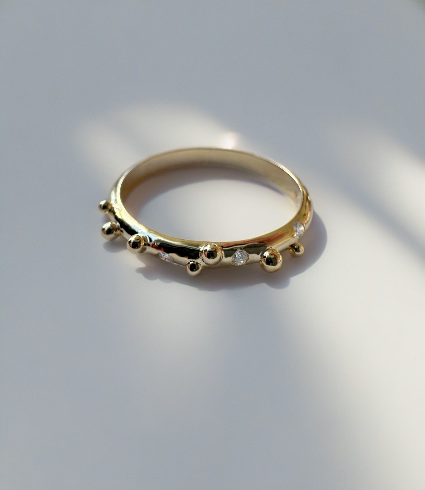 Elegant thin Diamond band, hand-crafted in 18k gold, this thin gold band features a smooth D shape band with gold granulations and 4 flushed diamonds of 1.4mm diameter each placed randomly between the granules | Ella Creations jewelry