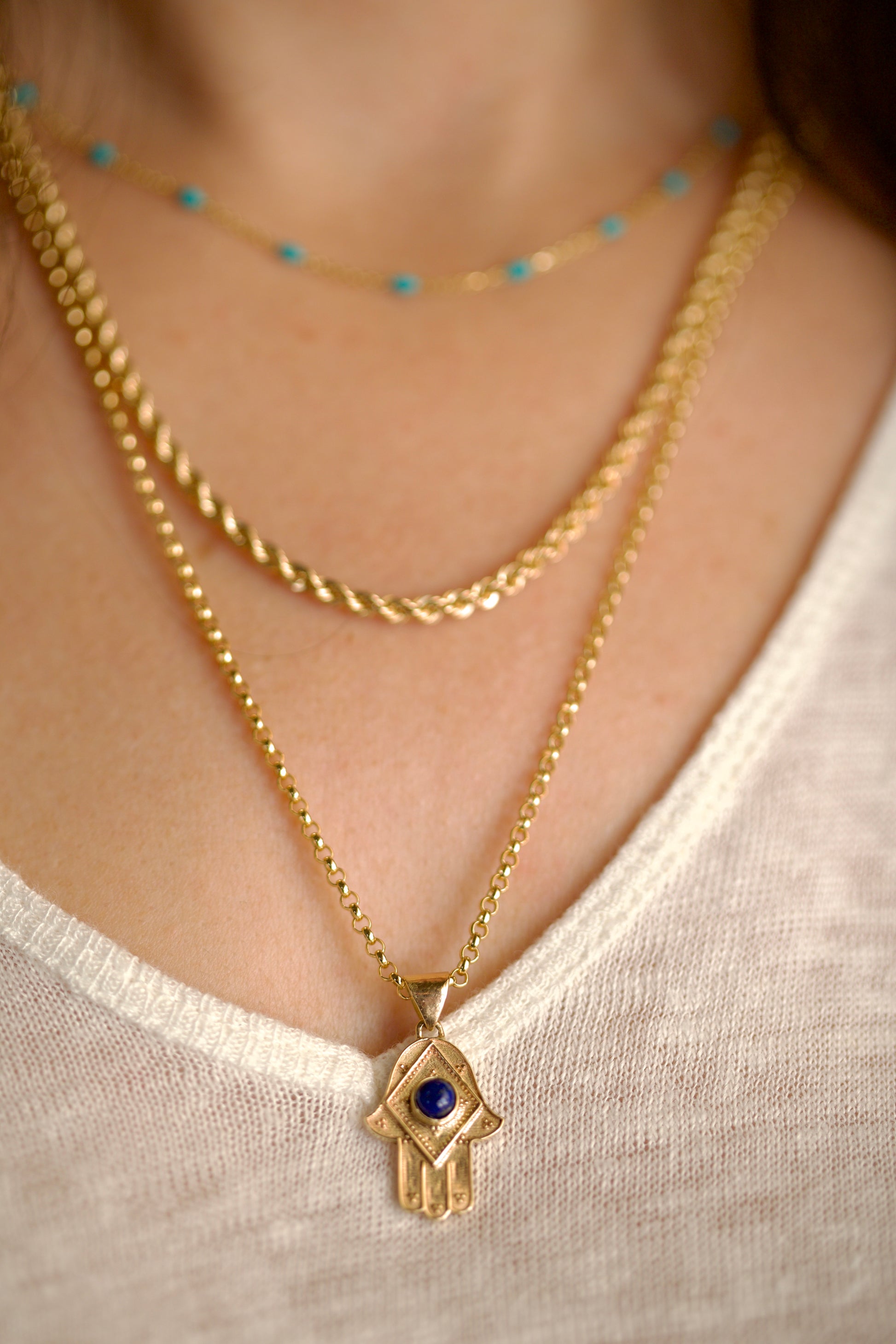 Stylish Gold Hamza Pendant adorned with a Lapis Lazuli Blue Stone at the center. Customizable in 14K or 18K