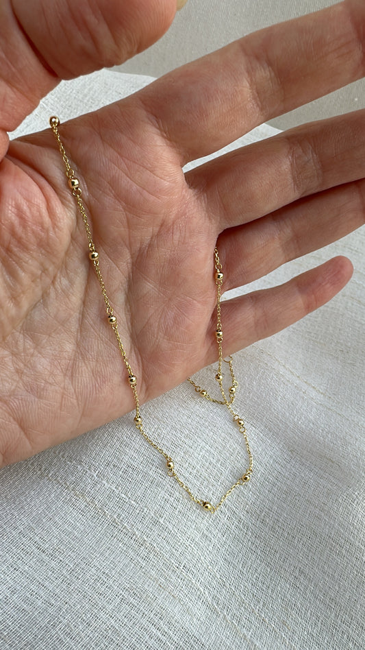 Delicate ball chain handcrafted in 18 karat gold featuring 2.5mm gold beads individually and manually wrapped onto the chain | Ella Creations Jewelry