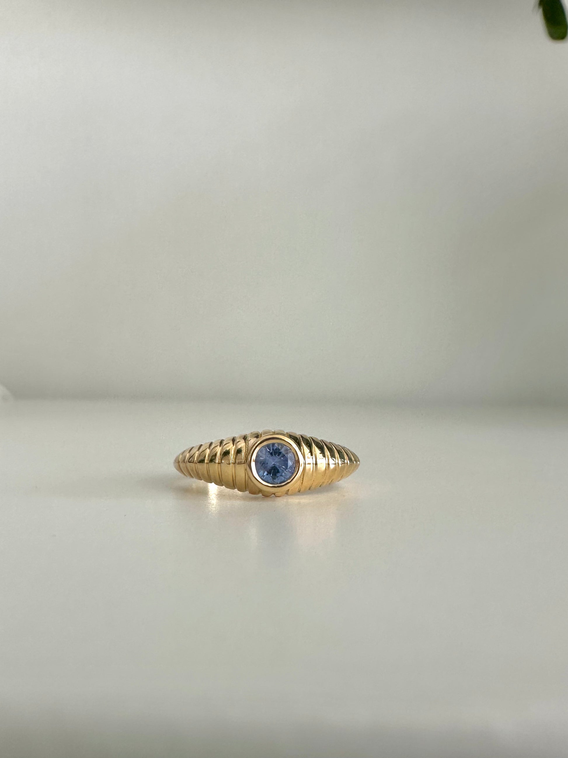 Gold Mina Sapphire Ring features a unique design that combines modern elements with a vintage-inspired aesthetic. It's a custom made ring showcasing a 4.3 mm bezel set Sapphire at its center | Ella Creations Jewelry