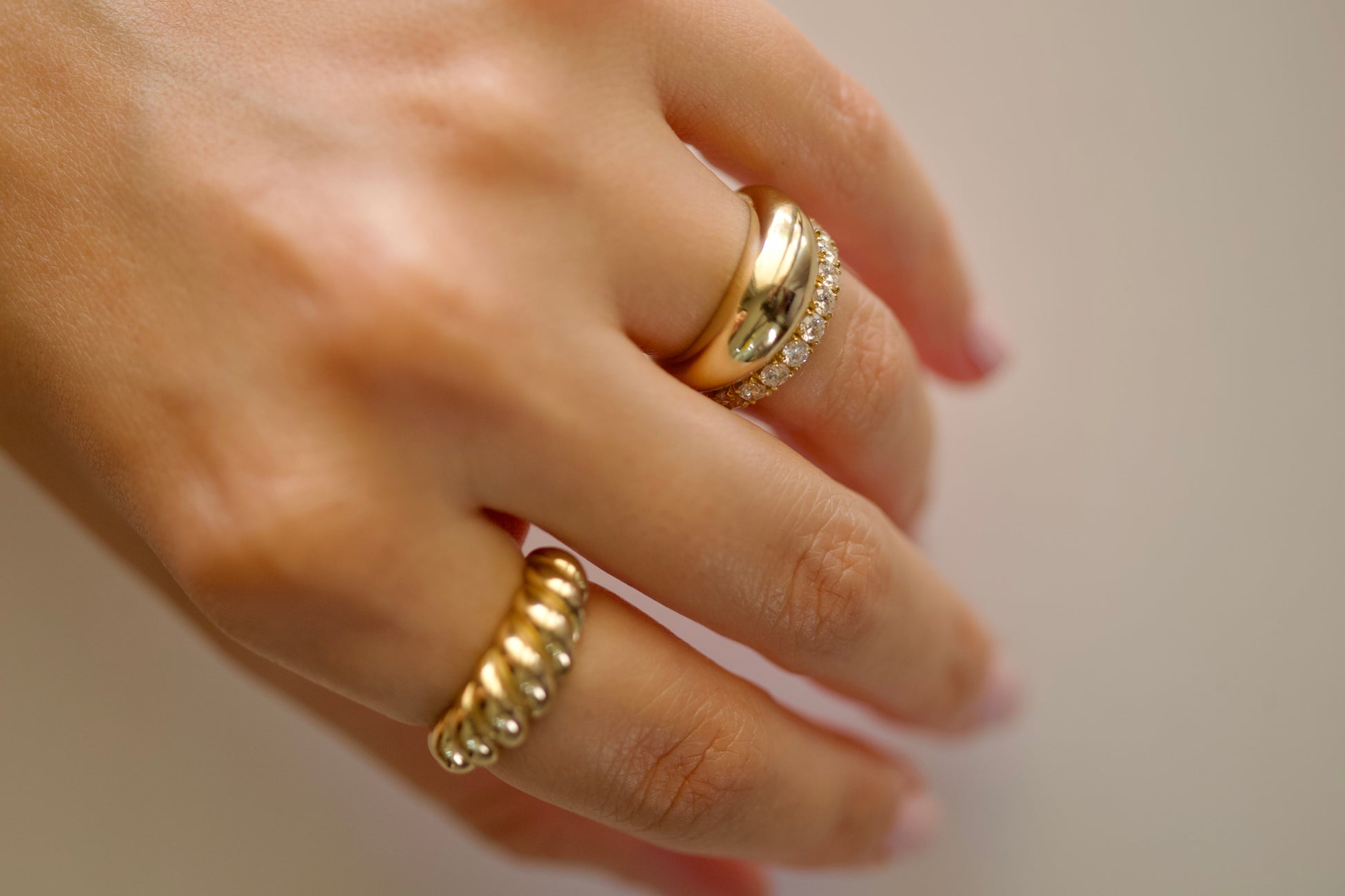 Gold croissant ring close-up, high polish twisted ridges