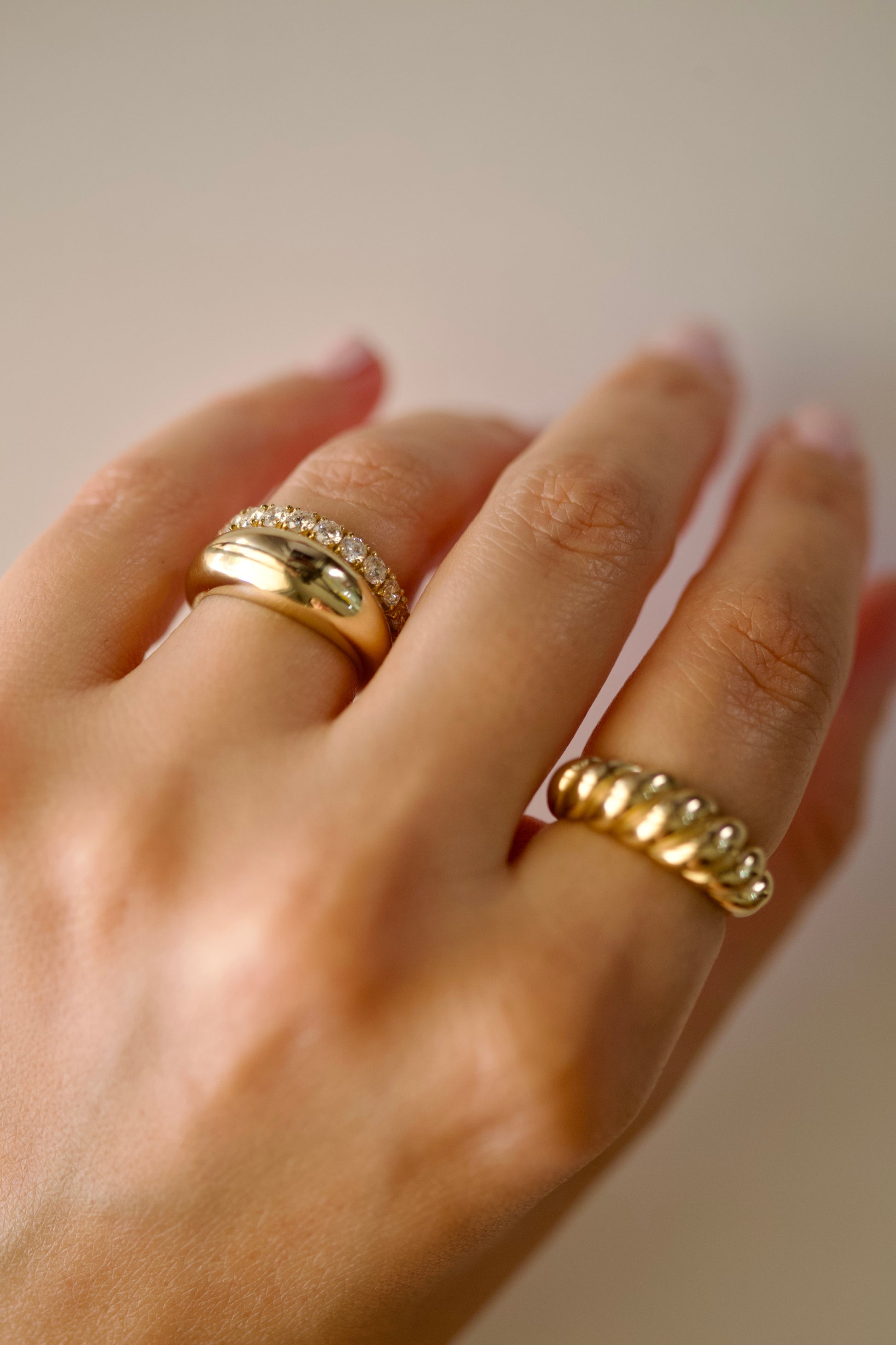 Twisted croissant ring worn in a gold ring stack | Ella Creations Jewelry 
