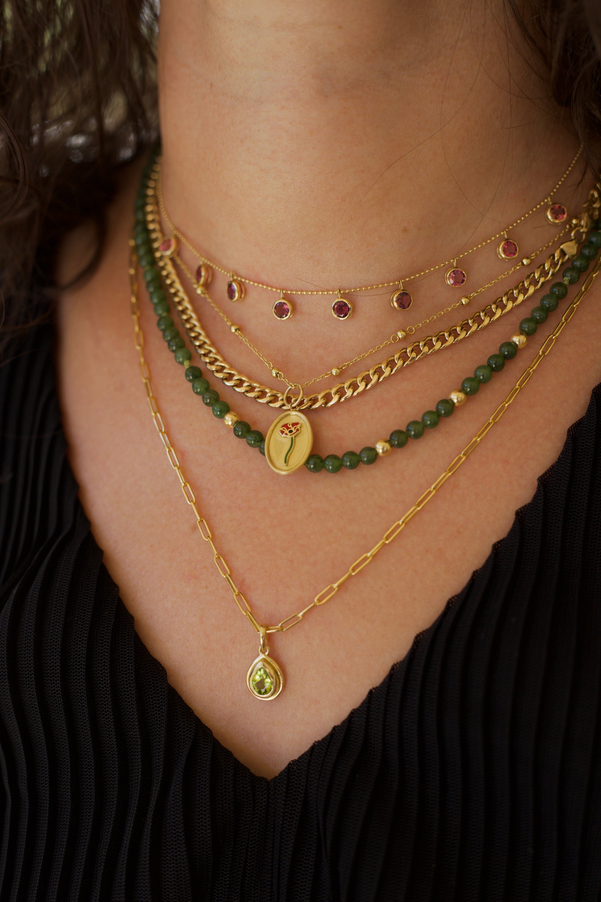 Peridot pendant, set into a custom, two-tiered 18k gold bezel that matches the stone's pear shape. The pendant has a solid gold back with an opening behind the stone to allow the light to best reflect the stone shade and sparkle.