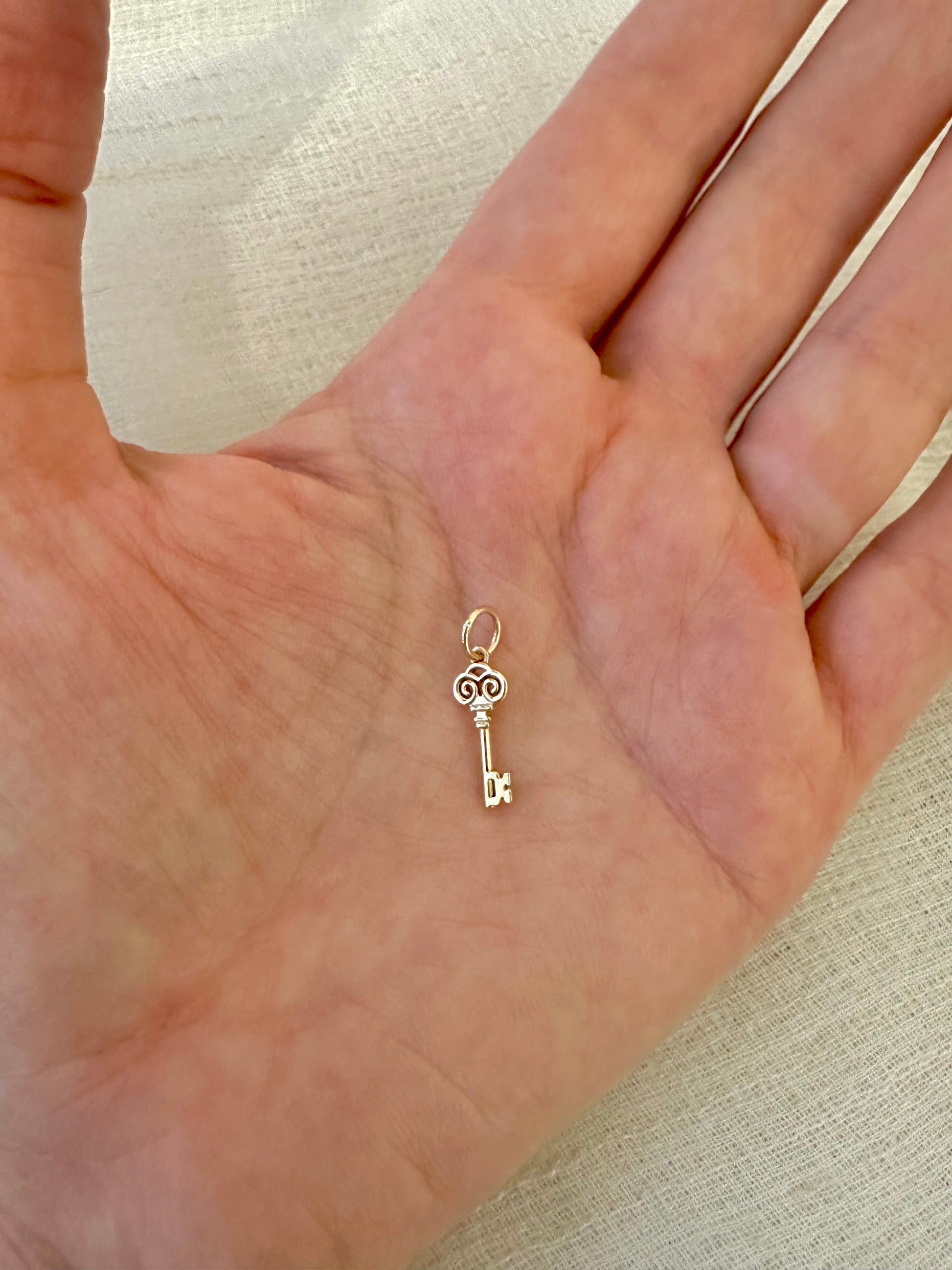 Gold Key charm inspired by the Palestinian Nakba and the hope to return, available in 14K and 18K 