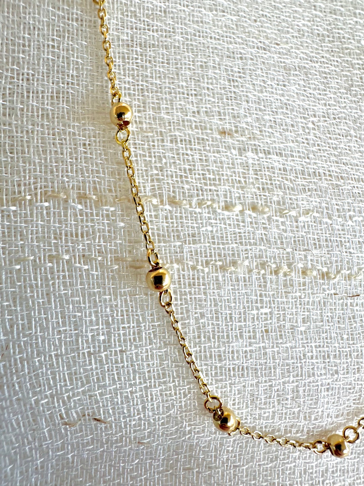 Delicate ball chain handcrafted in 18 karat gold featuring 2.5mm gold beads individually and manually wrapped onto the chain | Ella Creations Jewelry