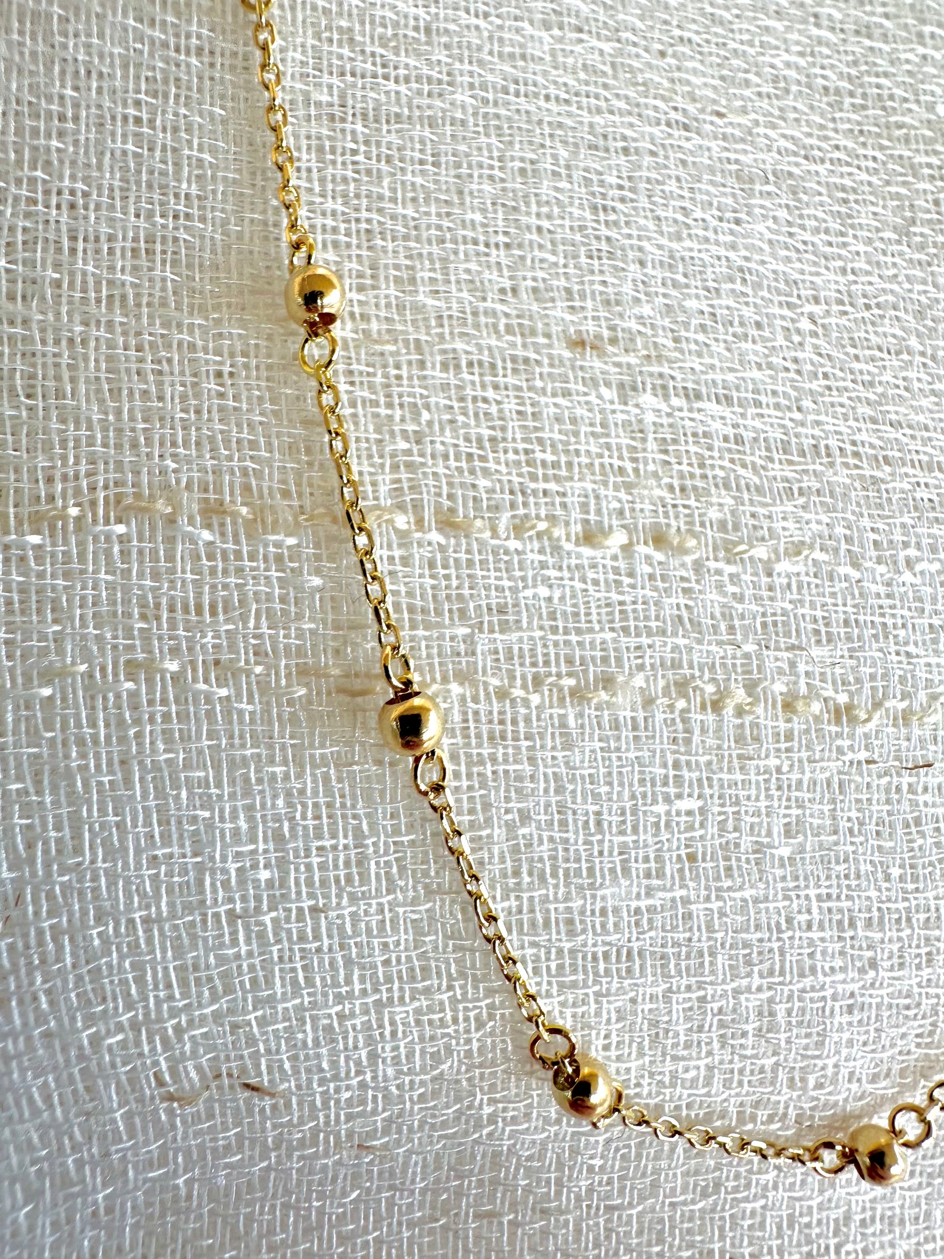 Delicate ball chain handcrafted in 18 karat gold featuring 2.5mm gold beads individually and manually wrapped onto the chain | Ella Creations Jewelry