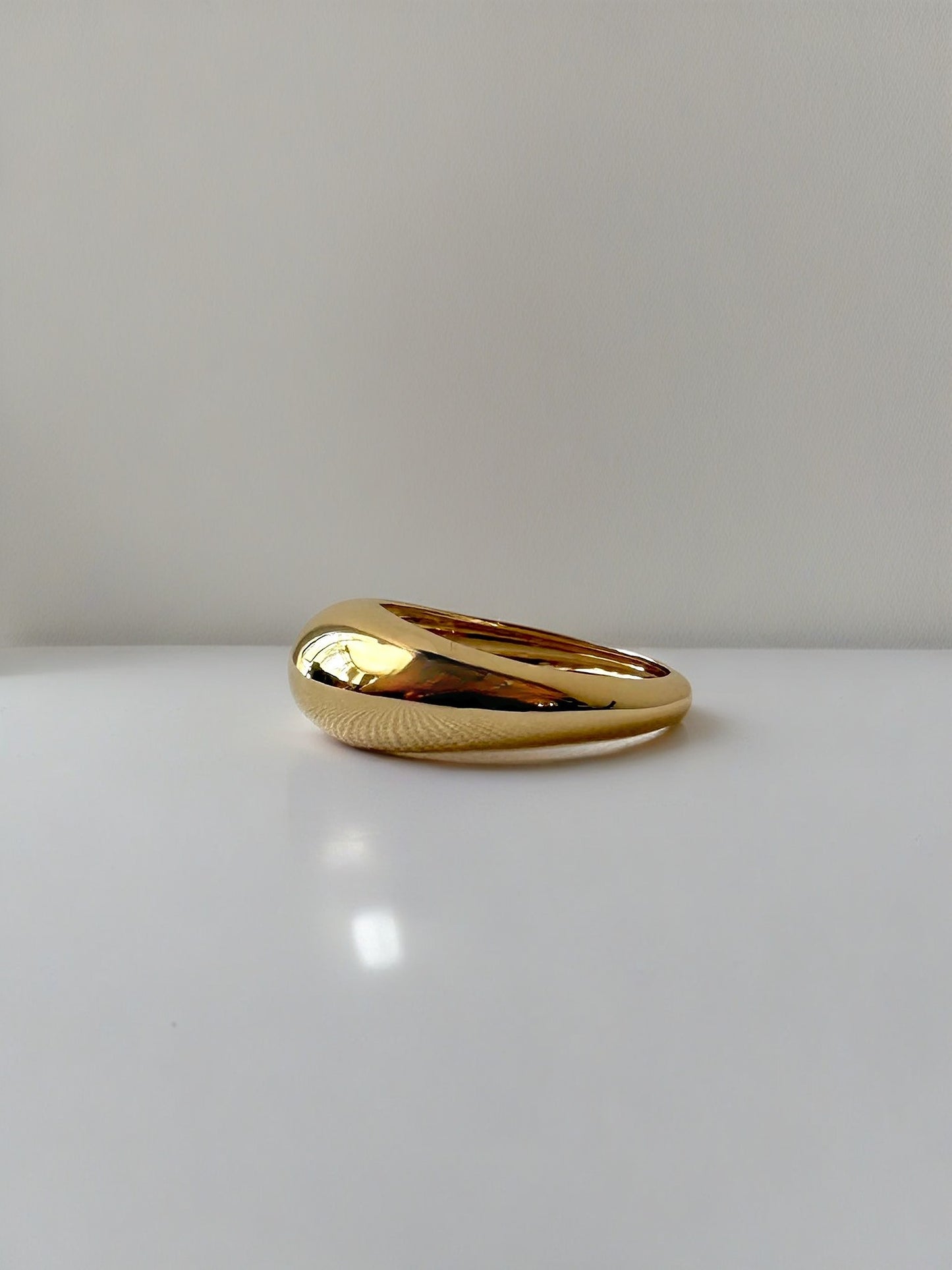 Gold Dome Ring handcrafted in 14k or 18k solid gold, the ring tampers from 7.5mm to 3mm | Ella Creations Jewelry 