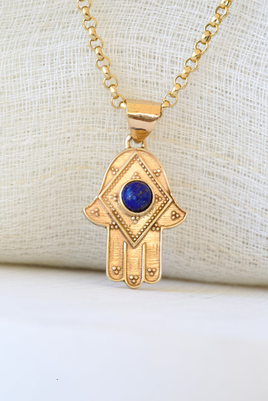 Stylish Gold Hamza Pendant adorned with a Lapis LazuliBlue Stone at the center. Customizable in 14K or 18K