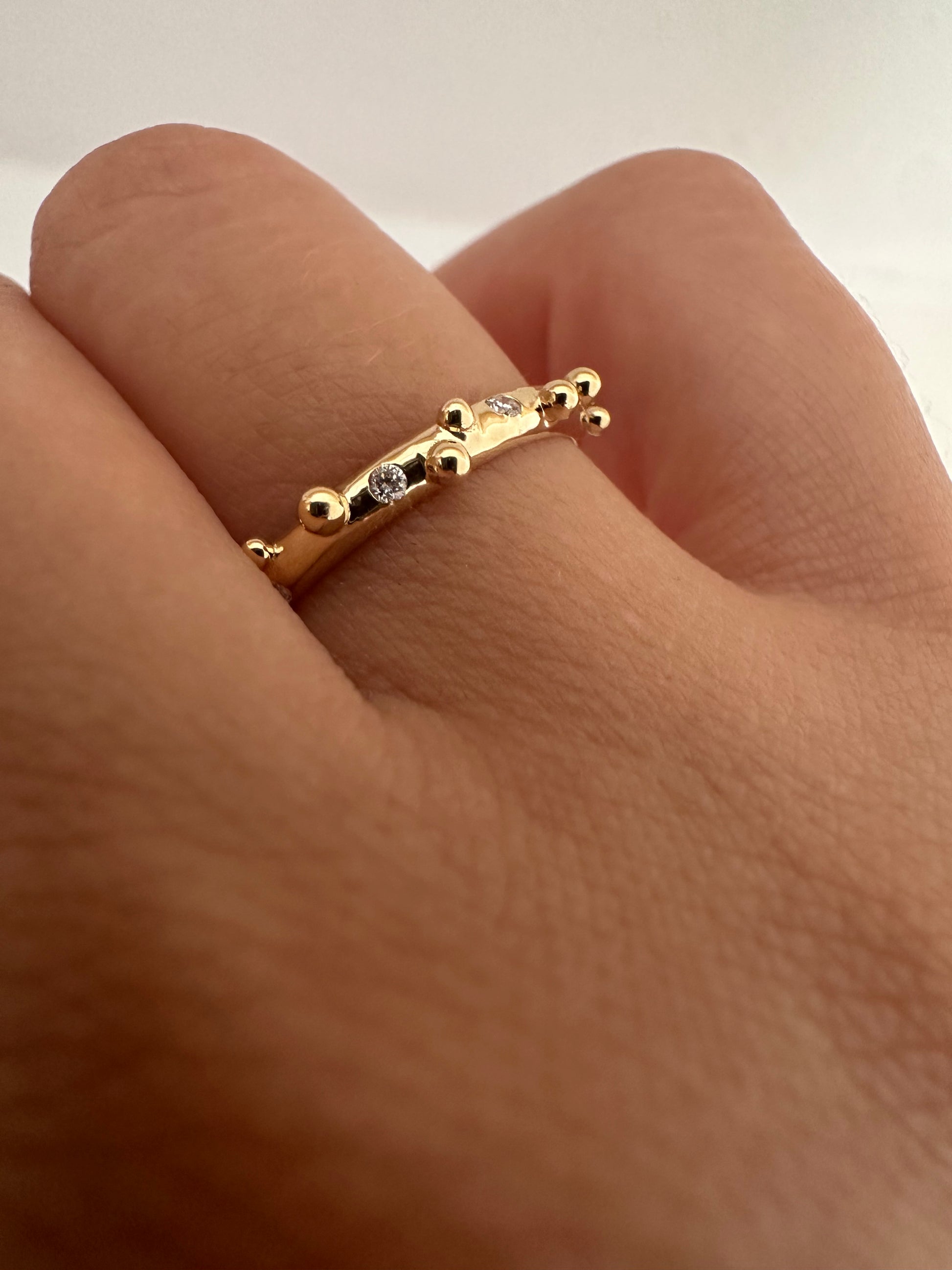 Elegant thin Diamond band, hand-crafted in 18k gold, this thin gold band features a smooth D shape band with gold granulations and 4 flushed diamonds of 1.4mm diameter each placed randomly between the granules. | Ella Creations jewelry