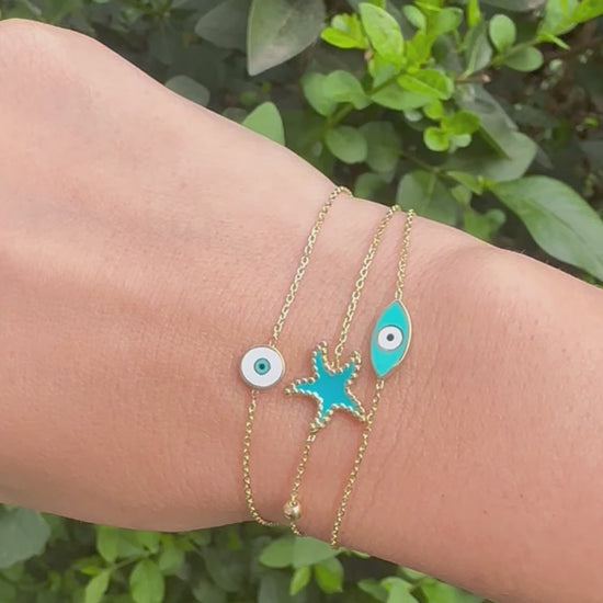 Exquisite Starfish Bracelet features a starfish charm at its center, available in Bright Turquoise and baby Pink finishes. Handcrafted in 18k gold and you can opt whether to have the charm only or an addition to a gold or enamel bead. | Ella Creations Jewelry