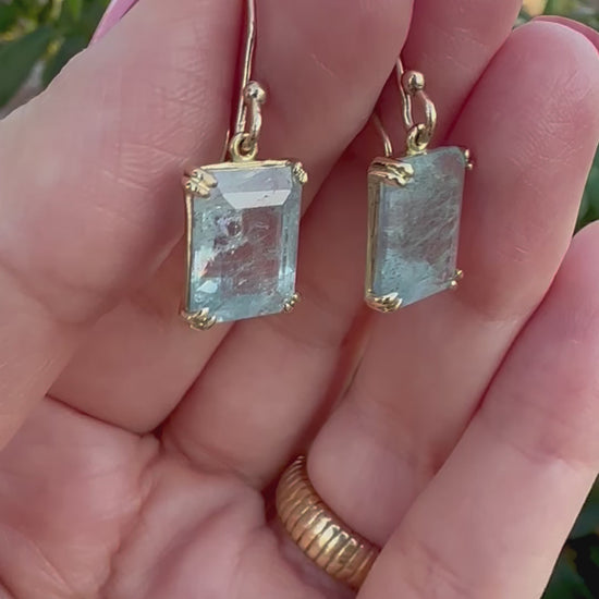 Elegant Drop Aquamarine Earrings handcrafted in 18 karat solid gold featuring emerald cut light green aquamarine stones in an open back prong setting and delicate french hooks. | Ella Creations Jewelry